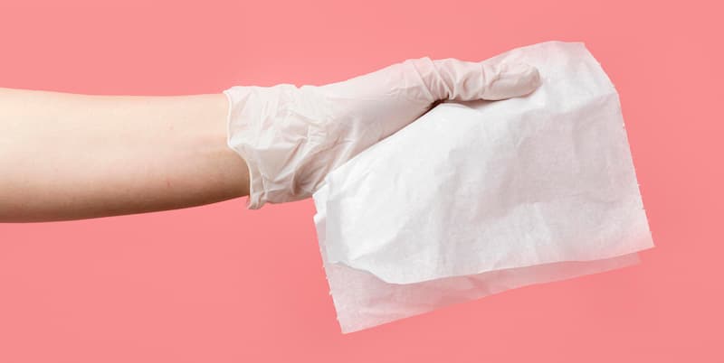 Person using a disinfection wipe sheet – cleaning application example
