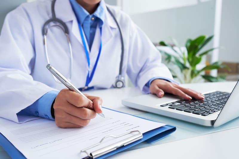 Doctor writing a medical form – application example for medical use
