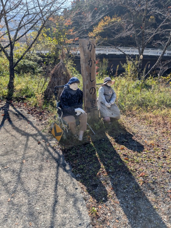 Scarecrows seated at the entrance to Nagoro village, greeting visitors